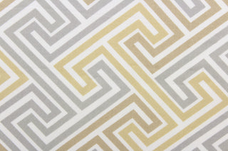 This fabric features a geometric design in  beige, khaki gray and white.