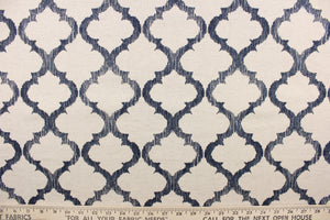 This fabric features a geometric design in dark navy blue against a natural background.
