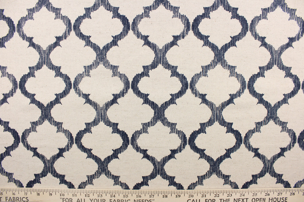 This fabric features a geometric design in dark navy blue against a natural background.