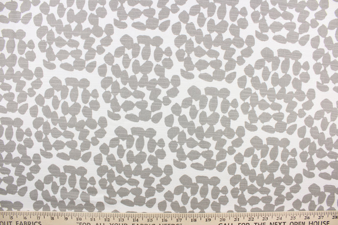 This fabric features a dot design in gray against white.
