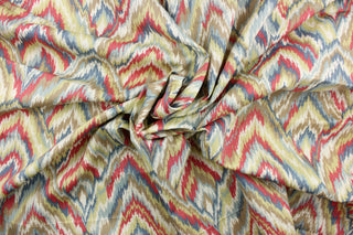 This fabric features a chevron design in blue, off white, beige, pale lime green, and dark pink. 