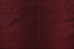 This taffeta fabric features a crinkle design in deep brunt red color.