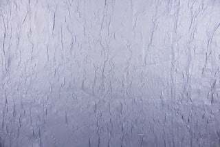 This taffeta fabric features a crinkle in iridescent silver blue color.