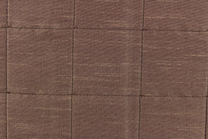  This beautiful jacquard fabric features an pin tuck block design in a taupe brown color