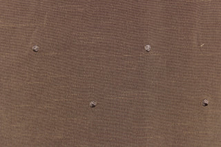 This beautiful jacquard fabric features an embroider nail head design in a rich tan color. 