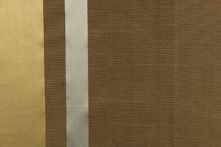 This stunning yarn dyed fabric features a striped pattern in brown, gray and gold. Enhancing the various colors of the stripes is a slight sheen.