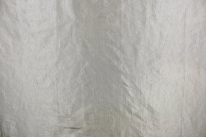 This taffeta fabric features a crinkle design in vibrant silver.