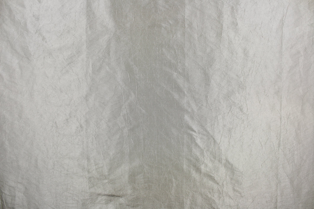 This taffeta fabric features a crinkle design in vibrant silver.