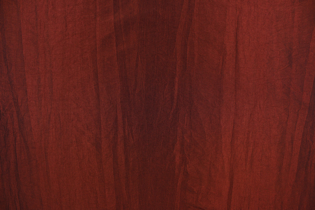 This taffeta fabric features a crinkle in a deep iridescent red. 