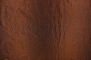 This taffeta fabric features a crinkle in a rich iridescent chocolate brown.