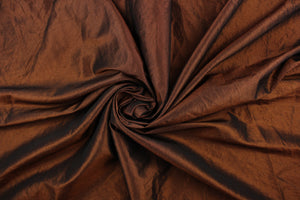 This taffeta fabric features a crinkle in a rich iridescent chocolate brown.