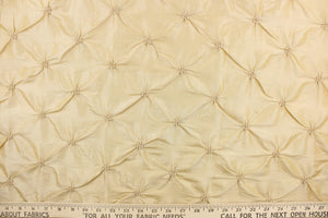 This beautiful jacquard fabric features an embroider gathered design in a golden khaki color.