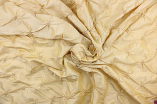 This beautiful jacquard fabric features an embroider gathered design in a golden khaki color.