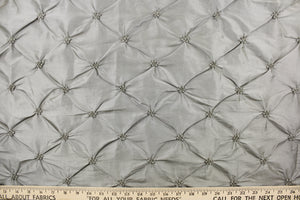 This beautiful jacquard fabric features an embroider gathered design in a silvery gray. 