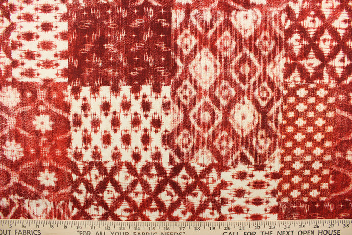 This fabric features a batik design in a garnet red and off white.