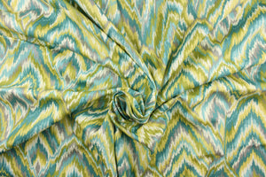 This fabric features a chevron design in  gray, turquoise, teal, off white, olive green, and pale yellow.