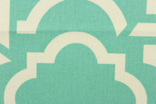 Load image into Gallery viewer, This fabric features a geometric design in white against turquoise green. 
