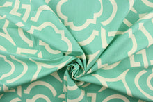 Load image into Gallery viewer, This fabric features a geometric design in white against turquoise green. 

