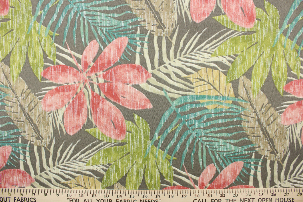  This outdoor fabric features a floral design in green, turquoise, khaki, beige, pink, and off white against a taupe background.