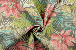  This outdoor fabric features a floral design in green, turquoise, khaki, beige, pink, and off white against a taupe background.