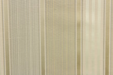 Load image into Gallery viewer,  Light weight and formal best portray this yarn dye fabric. Offering  varying  width striped pattern in a gold, light green, gray, and light beige color along with a slight sheen to enhance the various colors.
