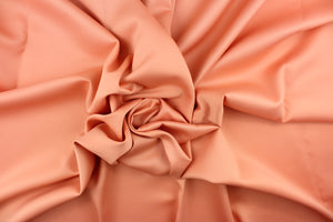 This beautiful versatile fabric offers a slight sheen in a solid coral.