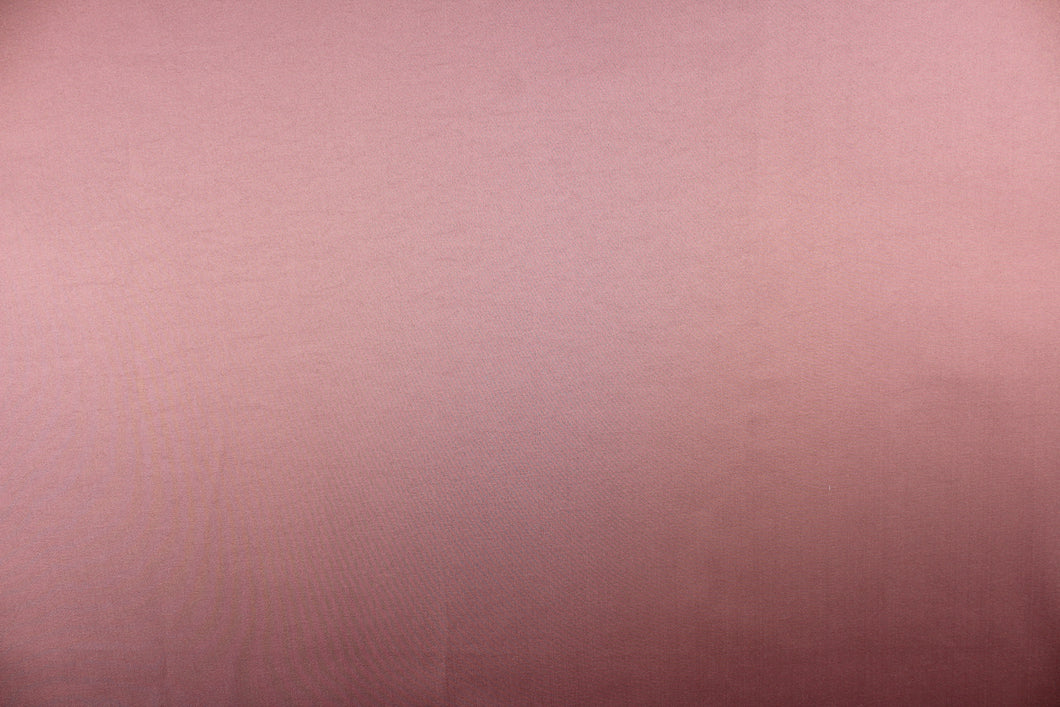 This beautiful versatile fabric offers a slight sheen in a solid light mauve. 