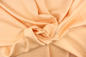 This beautiful versatile fabric offers a slight sheen in a solid peach.