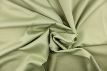 Load image into Gallery viewer, This beautiful versatile fabric offers a slight sheen in a solid light green.
