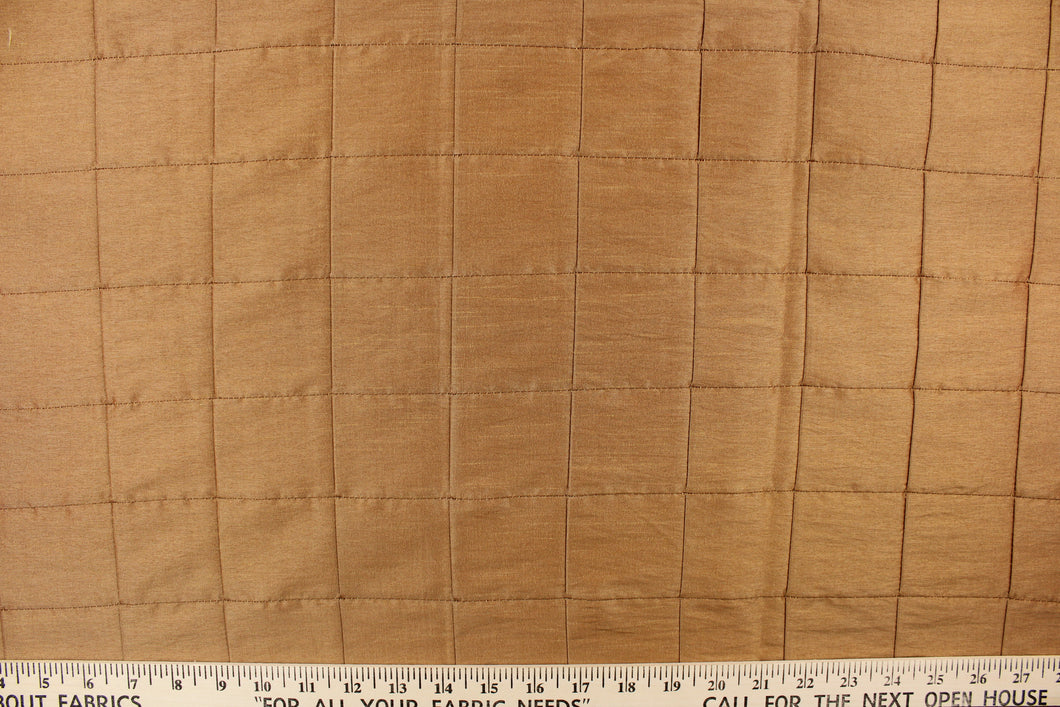 This beautiful jacquard fabric features an pin tuck block design in a rich golden tan color.