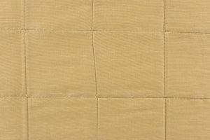This beautiful jacquard fabric features an pin tuck block design in a gold khaki color.