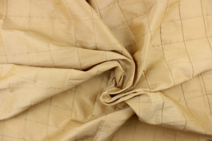 This beautiful jacquard fabric features an pin tuck block design in a gold khaki color.
