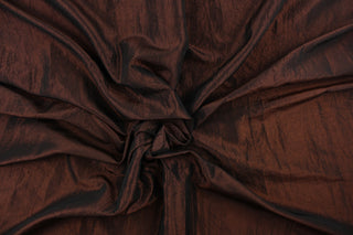 This taffeta fabric features a crinkle in iridescent rich brown. 