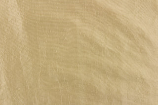  This taffeta fabric features a crinkle design in light gold.