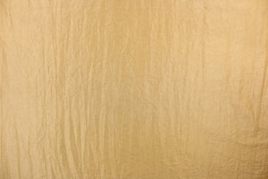 This taffeta fabric features a crinkle design in gold. 