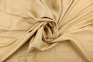 This beautiful jacquard fabric features an embroider nail head design in a khaki color