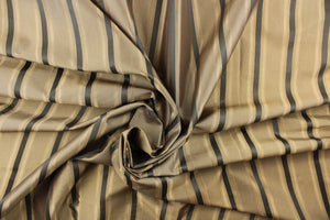 This stunning yarn dyed fabric features a striped pattern in gold tones and gray. 
