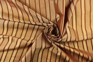This stunning yarn dyed fabric features a striped pattern in copper tones and gold.
