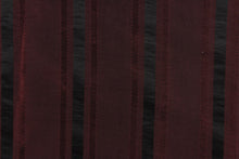 Load image into Gallery viewer, This stunning yarn dyed fabric features a striped pattern in a deep wine and black .
