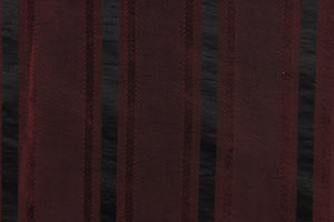 This stunning yarn dyed fabric features a striped pattern in a deep wine and black .