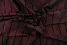 Load image into Gallery viewer, This stunning yarn dyed fabric features a striped pattern in a deep wine and black .
