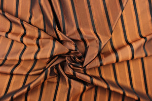 This stunning yarn dyed fabric features a striped pattern in bronze orange and black.