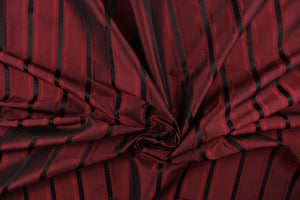 This stunning yarn dyed fabric features a striped pattern in deep red tone and black.
