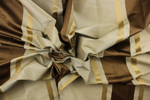 This stunning yarn dyed fabric features a  striped pattern in rich brown tones, gold and taupe. 