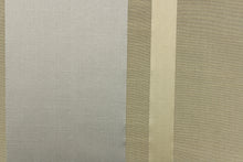 Load image into Gallery viewer, This stunning yarn dyed fabric features a striped pattern in gold, silver and khaki. 

