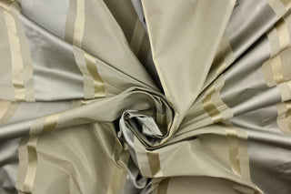 This stunning yarn dyed fabric features a striped pattern in gold, silver and khaki. 