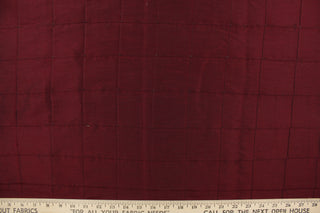 This beautiful jacquard fabric features an pin tuck block design in a  deep wine color. 