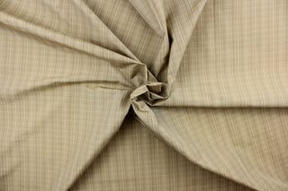 This stunning yarn dyed fabric features a small plaid design in shades of khaki and beige.