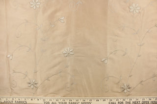 This beautiful jacquard fabric features an embroider floral design in a khaki color. 