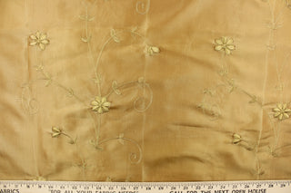 This beautiful jacquard fabric features an embroider floral  design in a golden tan